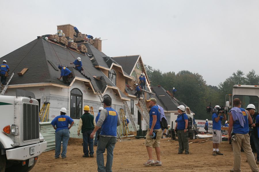 community members installing new roof